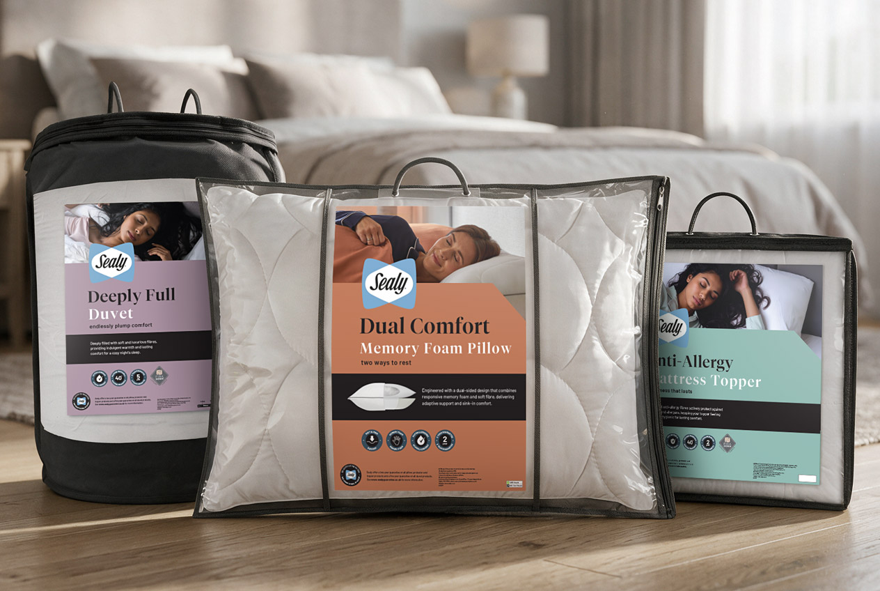 Sealy packaging range: Deeply Full duvet, Dual Comfort memory foam pillow and Anti-Allergy mattress topper, in a bedroom setting