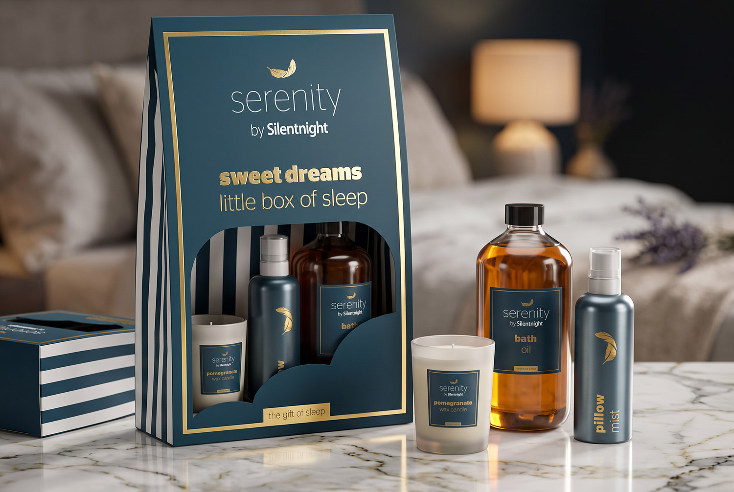 Serenity by Silentnight Little Box of Sleep gift set: pomegranate candle, pillow mist and bath oil, on a marble surface