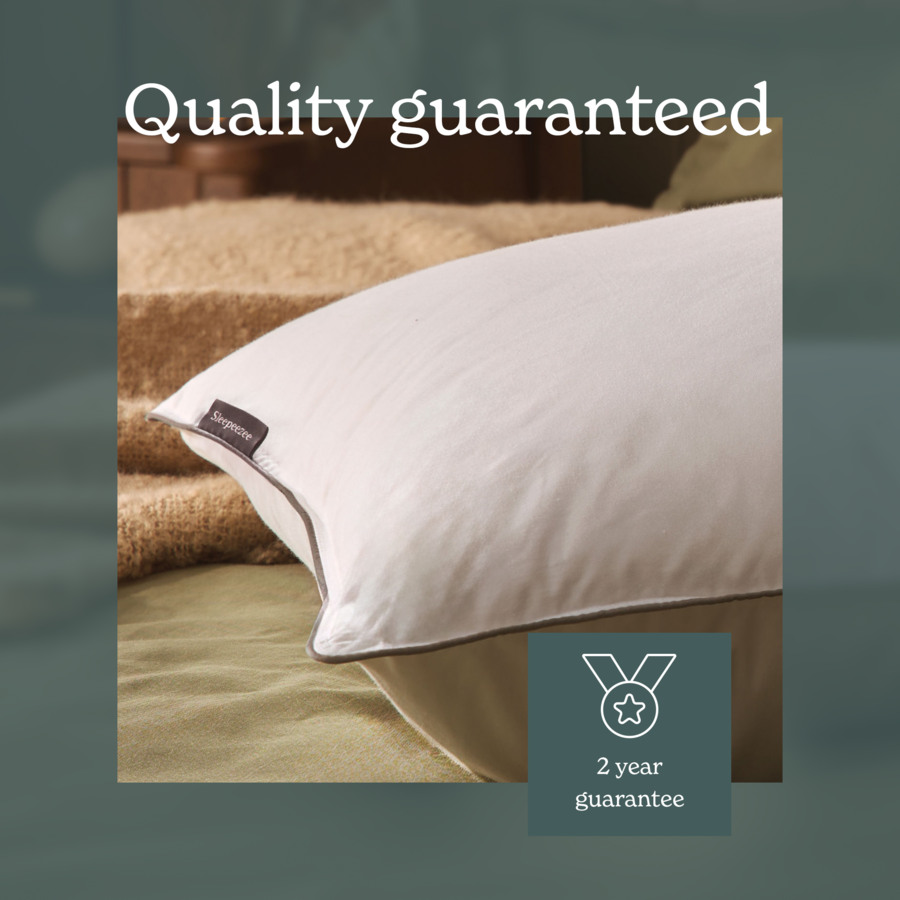 Close-up of a Sleepeezee pillow with a Quality guaranteed banner and 2 year guarantee icon