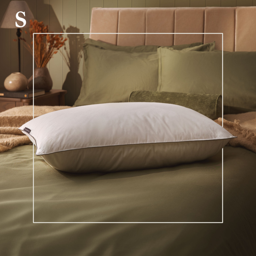 Sleepeezee Feather & Down pillow product shot, styled bedroom with monogram graphic